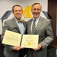 Freed receives the Distinguished Faculty Achievement Award from Domenico Grasso, U-M's interim president.