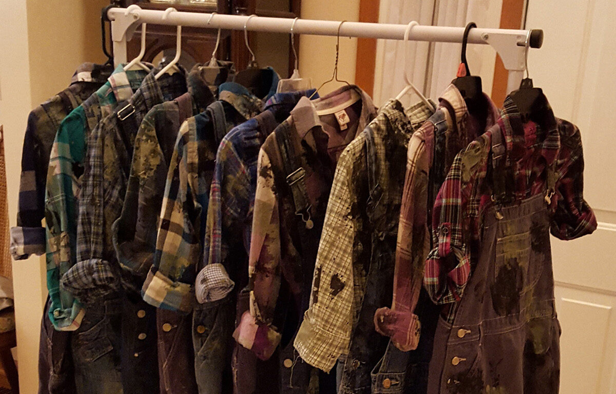 A rack of painted miners’ costumes that McCormick helped create for a production of “The Phantom Tollbooth.”